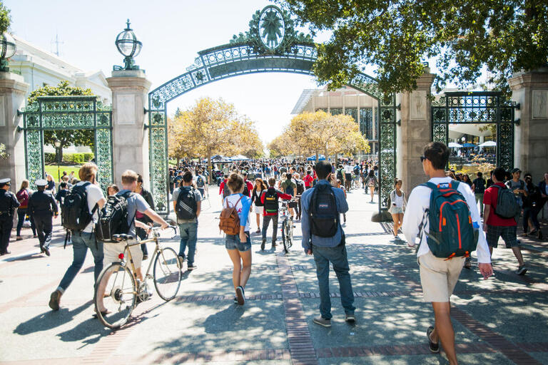 Students walking under Sather Gate